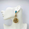 Handgemaakt statement oorbel earrings aqua cowrie shell handgemaakt door MUZE earrings. Gratis geleverd binnen nederland en belgie.