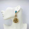 Handgemaakt statement oorbel earrings aqua cowrie shell handgemaakt door MUZE earrings. Gratis geleverd binnen nederland en belgie.
