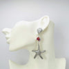 Handgemaakt statement oorbel earrings fuchsia pink shell handgemaakt door MUZE earrings. Gratis geleverd binnen nederland en belgie.